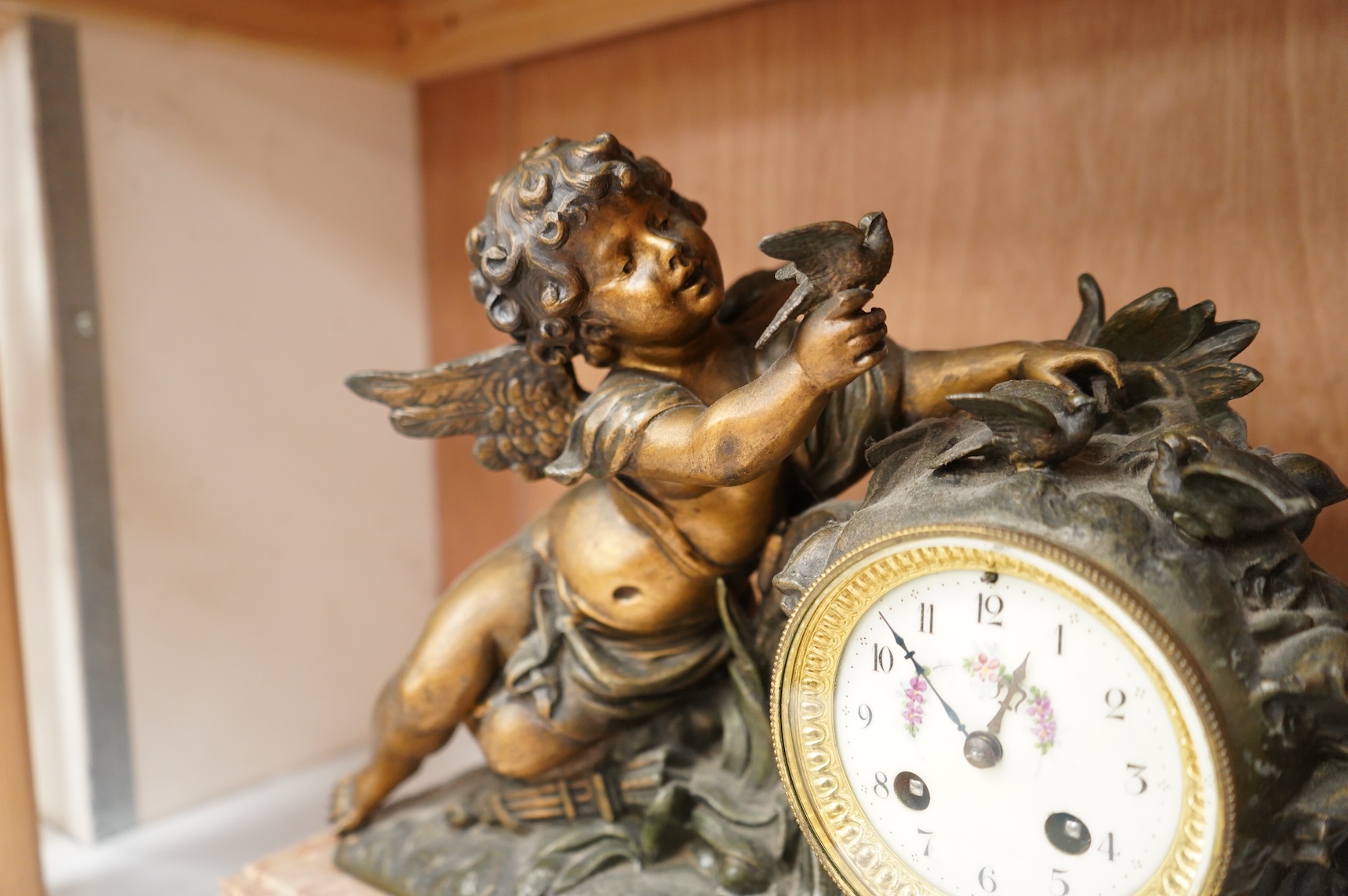 After Georges Maxim (French, 1885-1940), ‘Le Charmeur’, an early 20th century gilt spelter and rouge marble mantel clock, 39cm wide